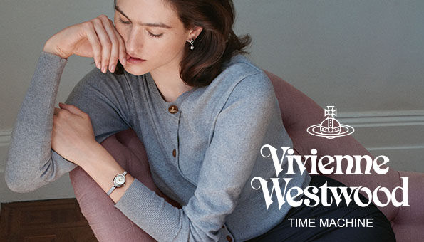 Woman seated on a pink chair wearing a silver Vivienne Westwood watch, with &ldquo;Time Machine&rdquo; branding.